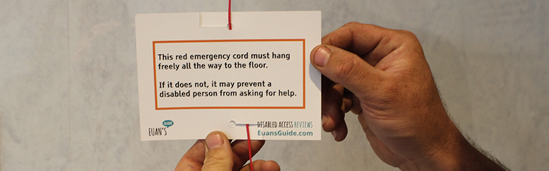 Image of someone attaching a Red Cord Card to a red emergency cord.