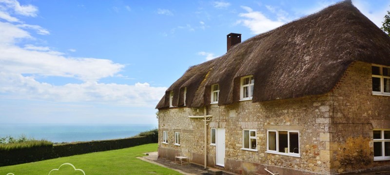 Photo of one of the Dream Cottages with thatched roof.