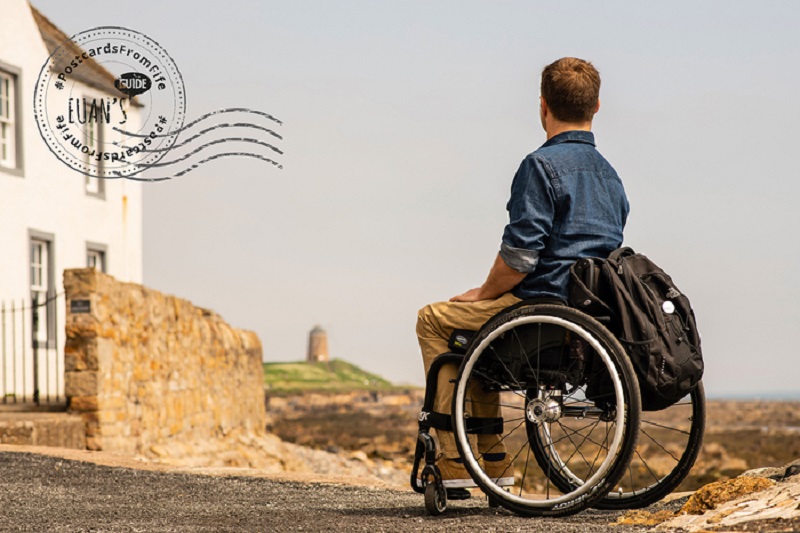 A postcard from Fife showing Ryan, a wheelchair user, looking towards St Monans Windmill.