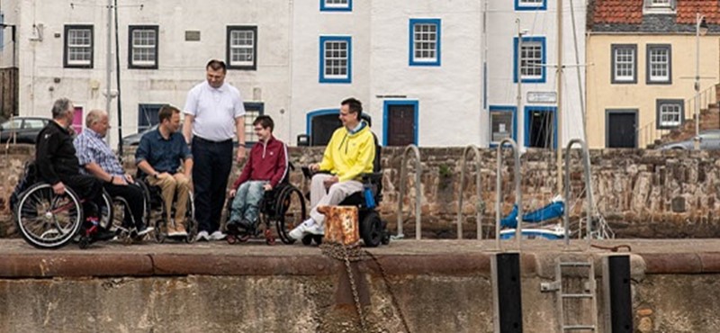 Photo of Euan's Guide Ambassadors on a harbour in Fife.