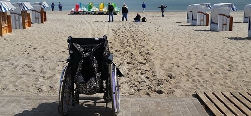 Photo of a wheelchair on a beach.