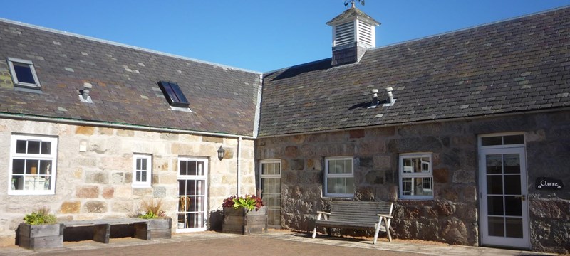 Photo showing the exterior of a cottage at Crathie Opportunity Holidays.