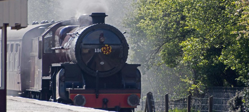Photo of a steam locomotive pulling passenger carriages on the East Lancs Railway.
