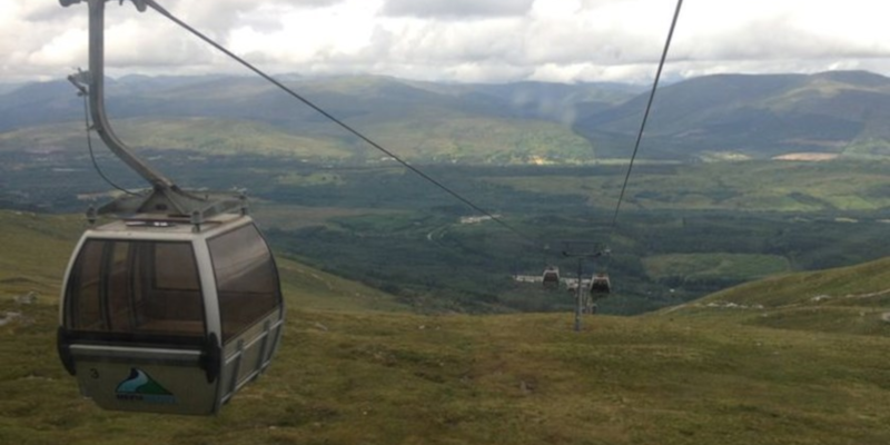 Photo of the Nevis Range Gondola in operation with mountains visible in the distance.