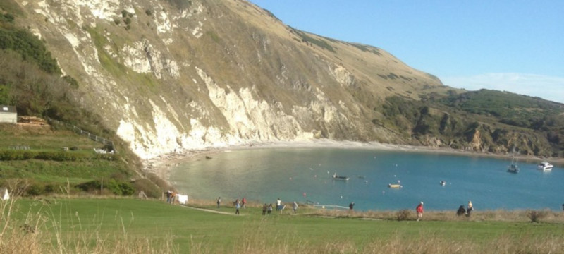 Photo of Lulworth Cove in sunny weather.