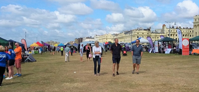 Photo:  Early morning view of Hove Lawns, with stalls and stage, with the first visitors arriving