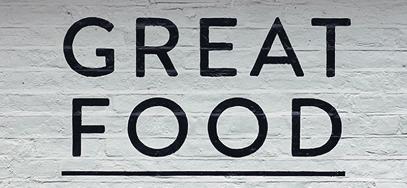 Brick wall with the text 'great food' written on it