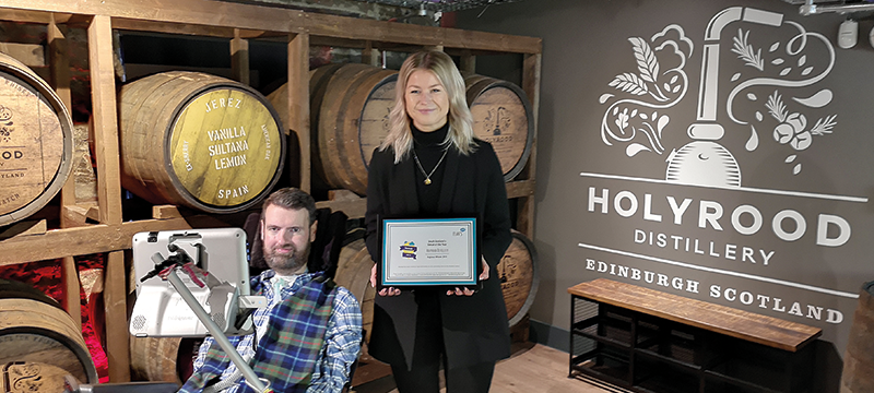 Image of Euan presenting the award to Holyrood Distillery