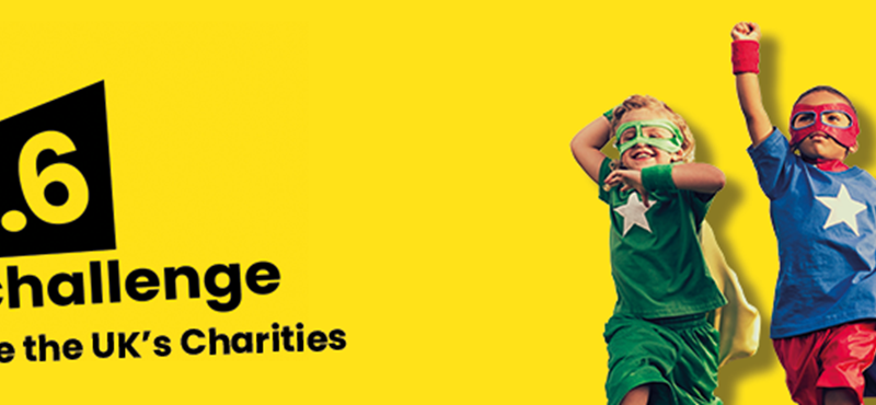 Yellow background image with The 2.6 Challenge logo. On the right hand side there is an image of two boys dressed as superheroes.