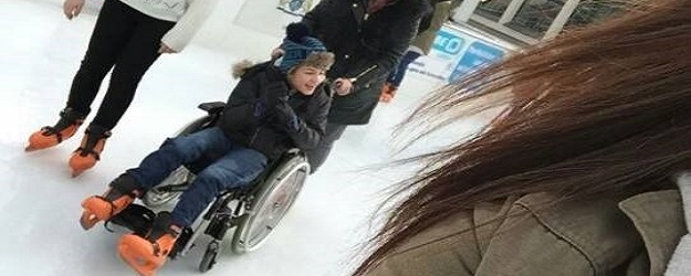 Photo of a wheelchair-user skating.