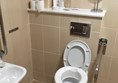 Toilet area with own raised seat