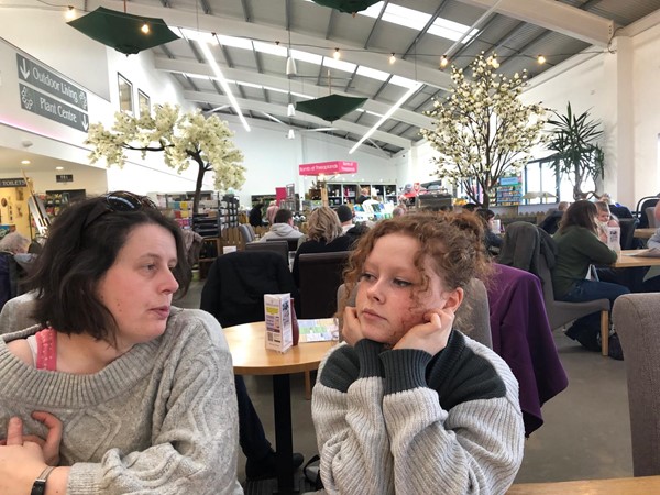 Picture of two people in a cafe