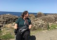 Image of myself in my powerchair facing the camera but looking over at the causeway.