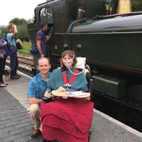 Wheelchair user with husband in front of a steam locomotive