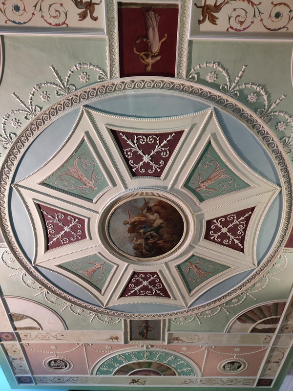 An eighteenth-century ceiling, fully intact, with elaborate decoration and many beautiful colours.