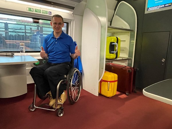 Paul on board the Eurostar and sitting in the dedicated wheelchair space.