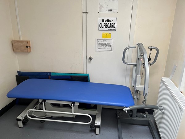 Image of the changing bed and portable hoist on the accessible toilet.