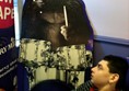 Picture of John-Luke looking at the standup poster at Cadbury World of the gorilla playing the drums