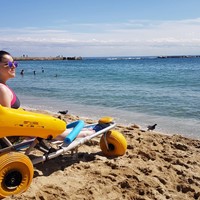 Sitting in a beach wheelchair on the beach in Barcelona
