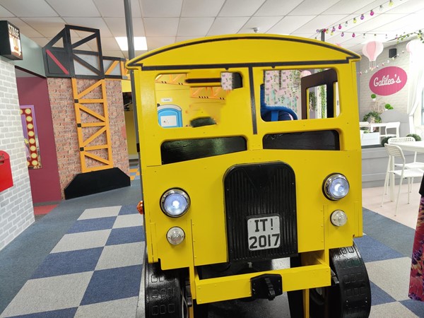 Picture of a yellow bus made of wood