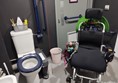 Chunky electric wheelchair showing how much space is available in the accessible loo