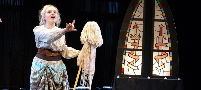 Photo of a lady with a mop performing in The Tale of Cockatrice.