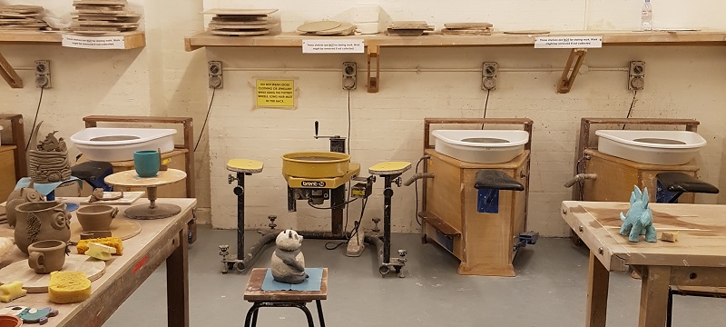 Photo of the pottery room with wheelchair accessible pottery wheel.