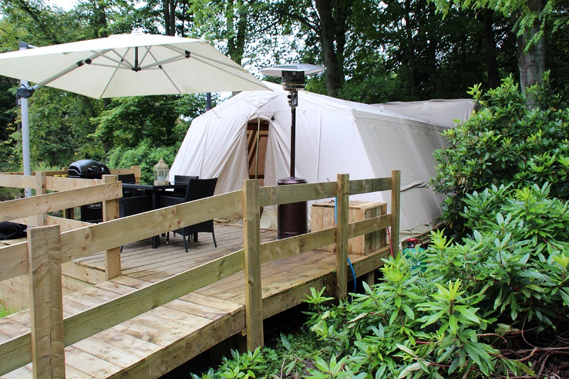 Photo of the wooden ramp and patio outside Wren Canvas Cottage.
