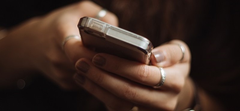 Photo of a person using a mobile phone.