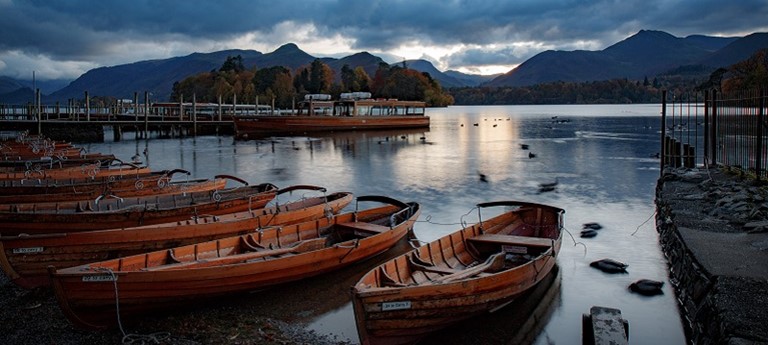 Photo of a lake and rowing boats.