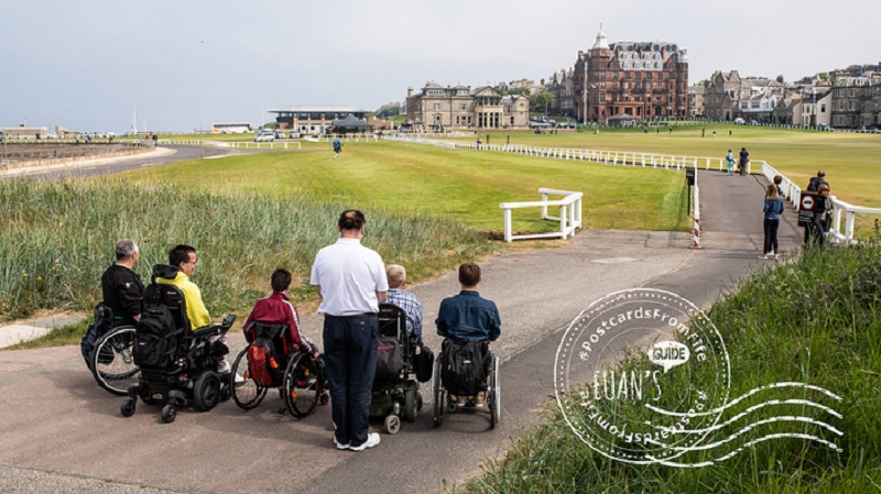 Postcard of wheelchair users at Old Course in St Andrews.