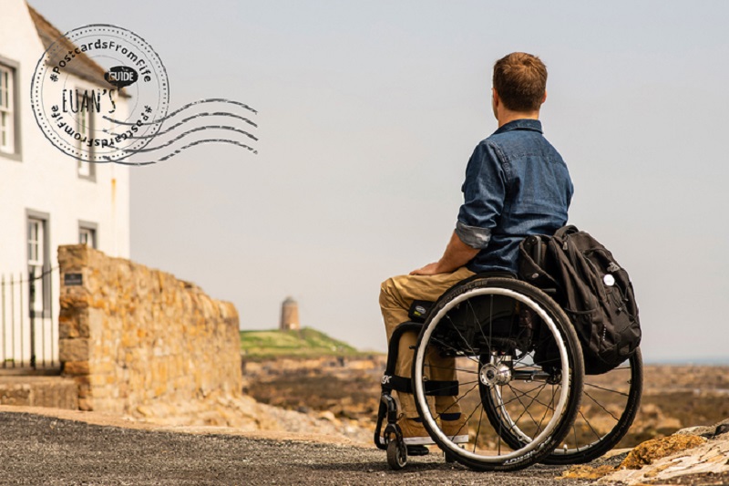 Postcard of Ryan, a wheelchair user, looking at St Monans Windmill.