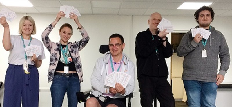 Photo of members of the Euan's Guide team holding Red Cord Cards.