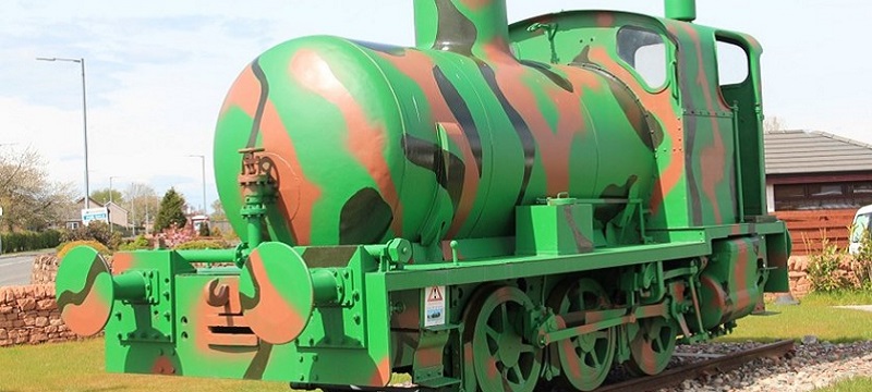 Photo of a camouflage painted train.
