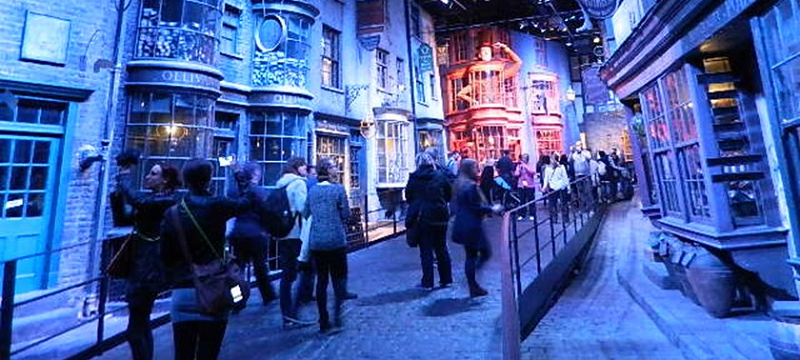 Photo of a crowd walking next to Harry Potter's Diagon Alley set in Warner Bros. studio.