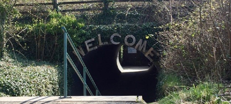 Photo of a dark underpass with steps leading down to it.