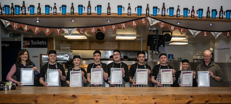 Photo of Real Food Cafe staff holding access awareness certificates.