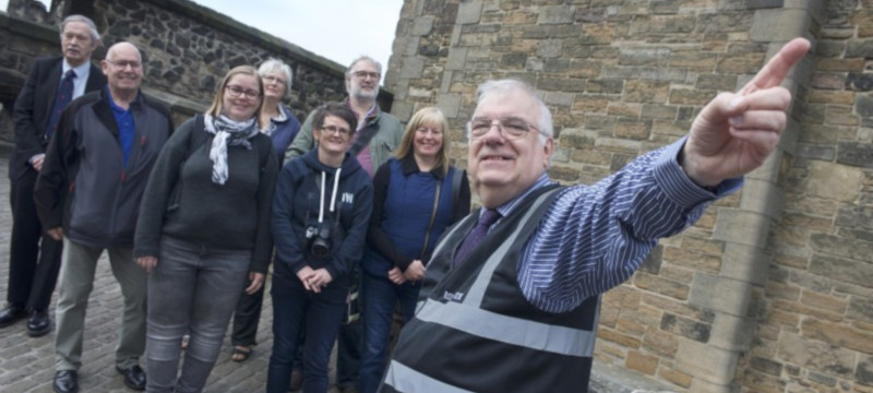 John Hay pictured with a tour group at Edinburgh Castle.