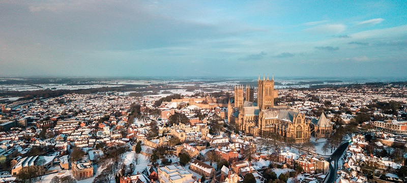 Bird's eye view of a snowy Lincoln city and cathedral.