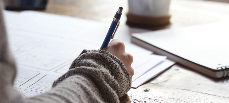 Photo of a student writing.