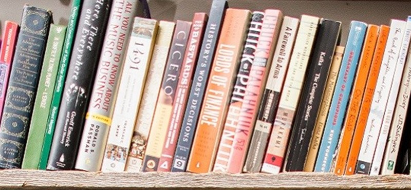 Photo of books on a shelf.