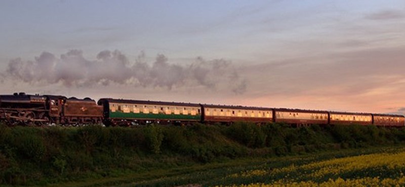 Photo of a steam locomotive pulling passenger carriages on the Mid Hants Railway.