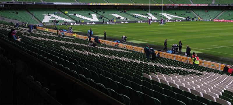 Image of empty Aviva stadium. In the distance the word 'Aviva' is spelt out over the seats.