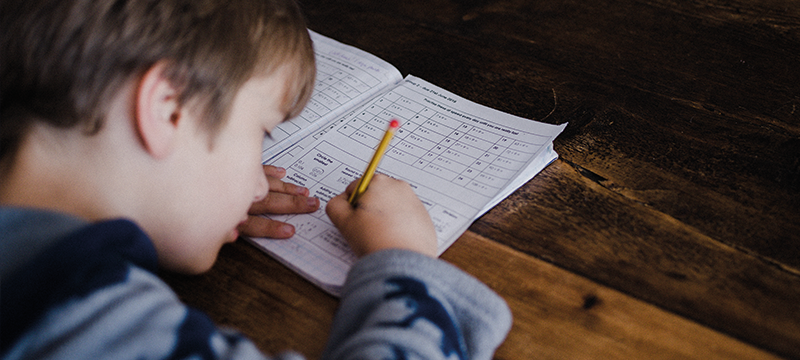 A child writing in a workbook
