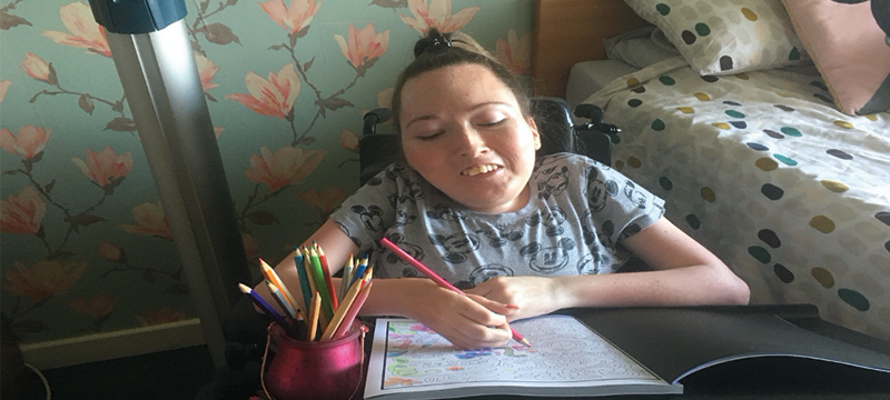 Image of Claire colouring in at home.