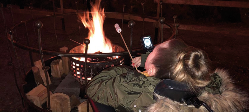 Image of Claire toasting a marshmallow at The Enchanted Forest.