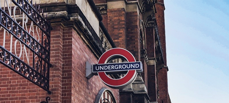 A red brick building with the London Underground sign attached.