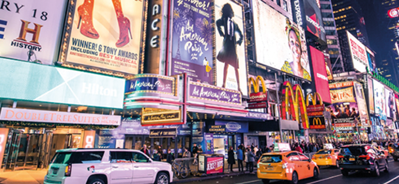 Billboards in New York City showing adverts for Broadway shows.