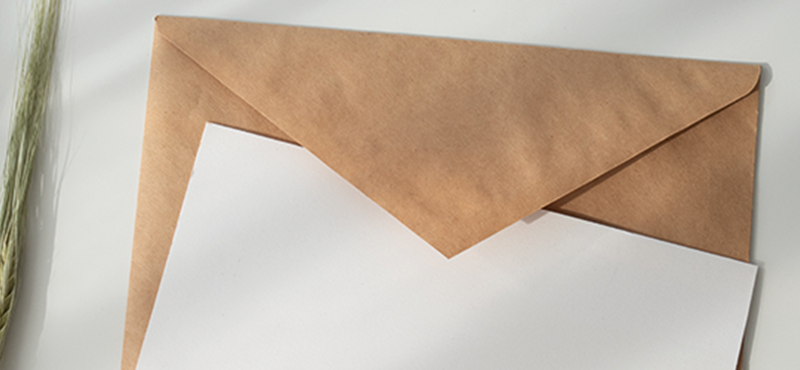 Image of a beige envelope covered by a plain white card.