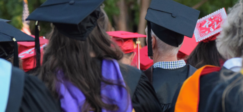 Image of people in graduation gowns and hats.